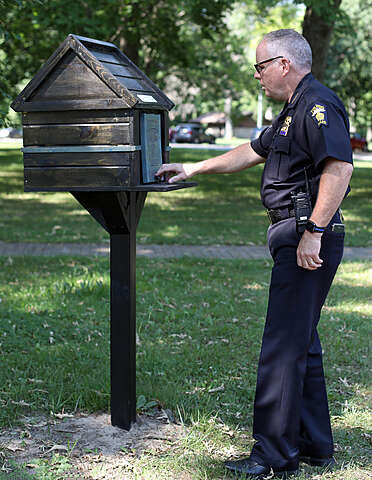 Police officer with little library